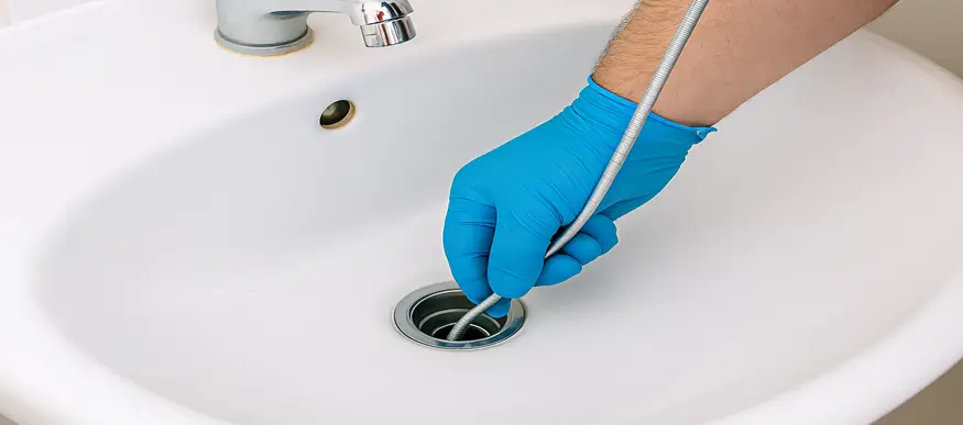 Plumber cleaning drain in Spring